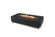 studio shot of the black marble-effect fire pit table against a plain white background, featuring a long, linear flame burning over dark glass media.