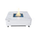 White marble Elementi Annecy 60,000 BTU fire table with a central burning flame and blue glass media.