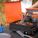 Close-up of adjustable burner knob on portable black camping griddle