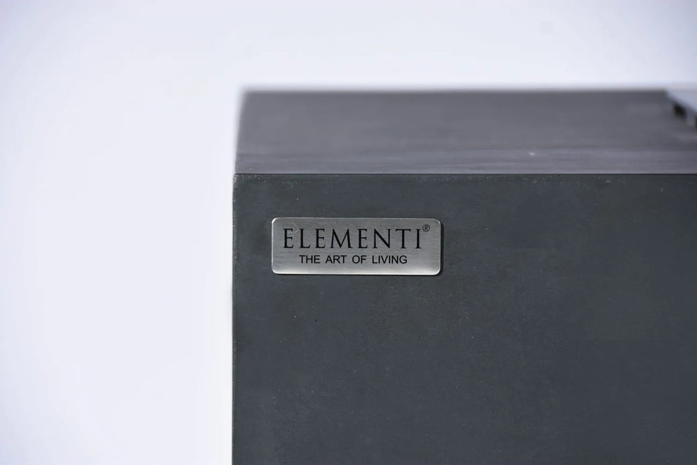 Close-up of the Elementi brand logo on the dark gray concrete finish of the Granville OFG121DG Fire Table.