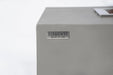 Detail of the Elementi Granville OFG121LG Fire Table logo plate on grey glass-fiber reinforced concrete.