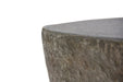 Close-up of the Boulder fire table's edge, highlighting the organic, rugged GFRC stone texture and smooth top surface.