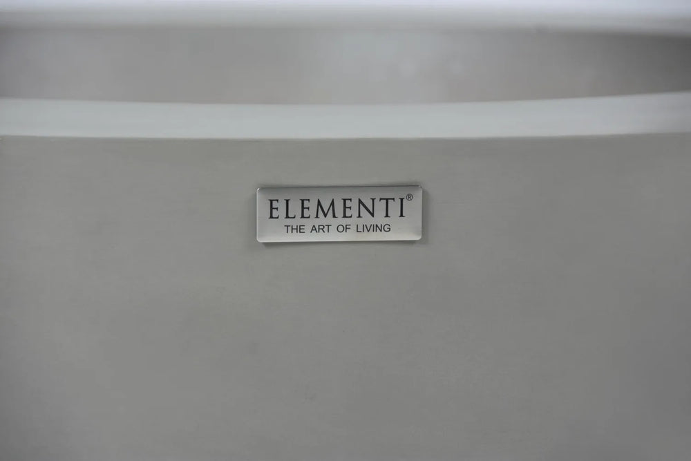 Close-up of the Elementi: The Art of Living silver logo plate on the side of a gray concrete fire pit.