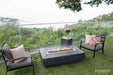 Beachfront patio featuring a lit Elementi Hampton OFG139DG Fire Table 56" Dark Gray with ocean views.
