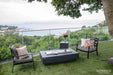 Elementi Hampton OFG139DG 56" Dark Gray Fire Table used as a coffee table with its stainless steel lid.