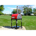 WPPO Traditional 25 dual fuel pizza oven with red dome, chimney, black cart, wheels, and outdoor lawn setting.