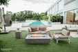 Low-profile Elementi Hampton OFG139LG fire table creating a warm outdoor lounge atmosphere at sunset.