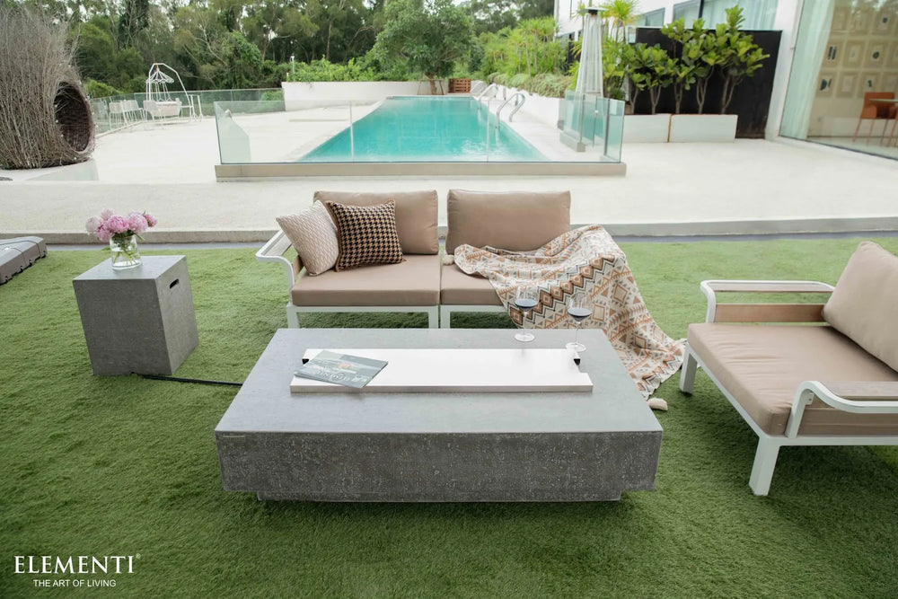 Elementi Hampton OFG139LG 56" Fire Table with a protective stainless steel lid covering the burner area.