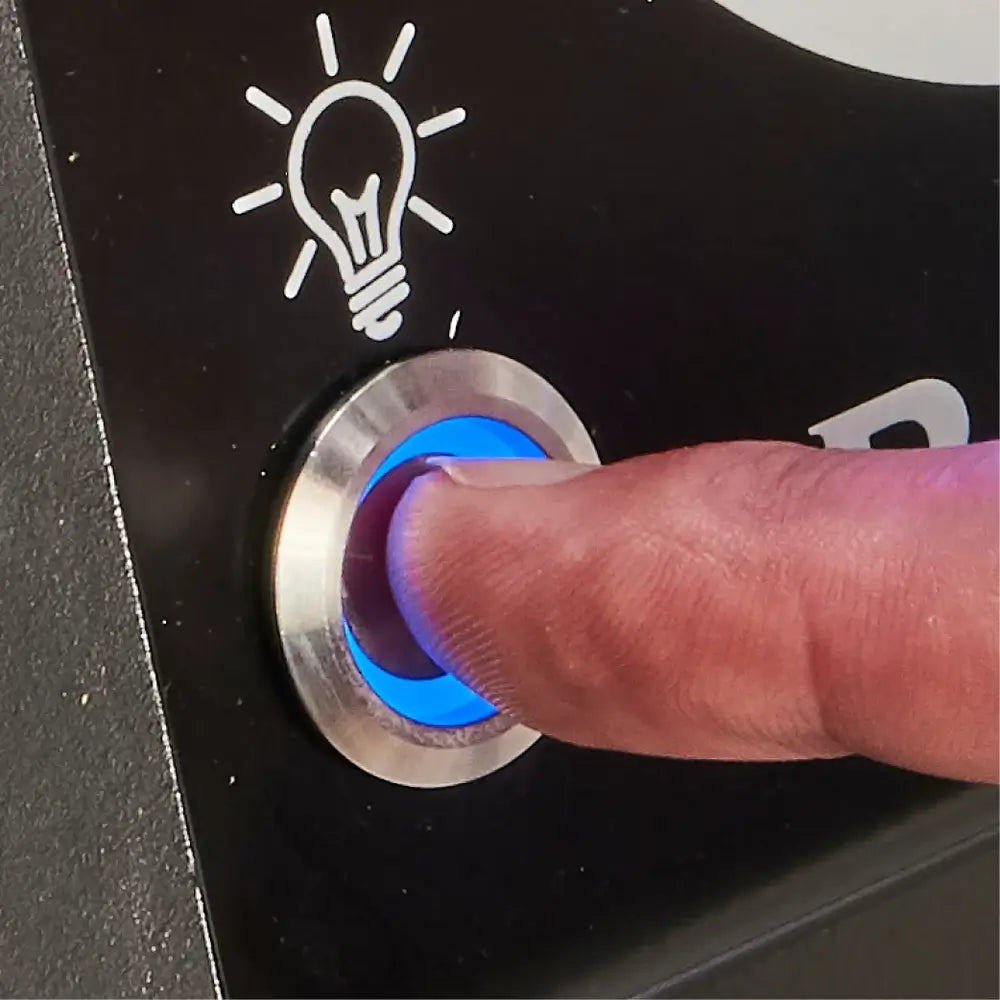 Close-up of the blue LED backlit light switch on a Broil King Baron 420 Shadow gas grill.