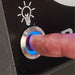 Close-up of the blue LED backlit light switch on a Broil King Baron 420 Shadow gas grill.
