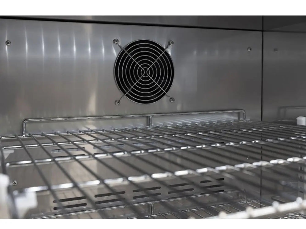 Interior detail of the Broil King 800149 fridge showing the forced-air cooling fan and heavy-duty wire shelving.