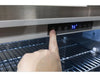User adjusting the digital thermostat on a Broil King 800149 outdoor refrigerator to customize the cooling temperature.