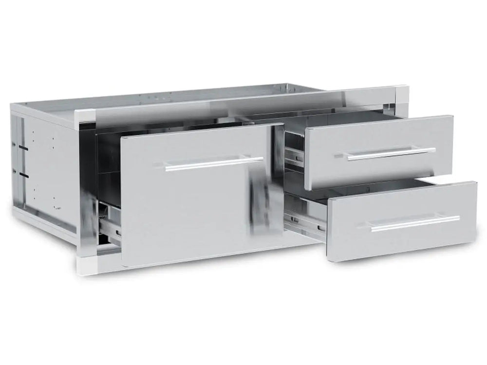 Open view of the Broil King 800910 stainless steel triple drawer unit showcasing the smooth-glide ball-bearing slides and deep storage capacity for BBQ tools and accessories.