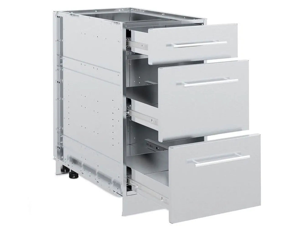 A three-quarter view of the Broil King 802500 stainless steel 3-drawer cabinet storage base with all three drawers fully extended, showcasing the internal storage capacity and drawer glides.