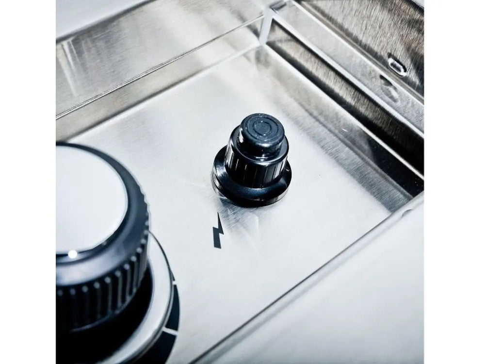 Close-up of the electronic ignitor button on the Broil King Imperial S100 built-in side burner.