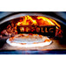 WPPO Karma oven baking pizza with a WPPO LLC stainless steel flame guard and bright wood flames.