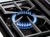 Close-up of a high-performance blue gas flame ignited on a Broil King Imperial series side burner with a heavy-duty cast iron grate.