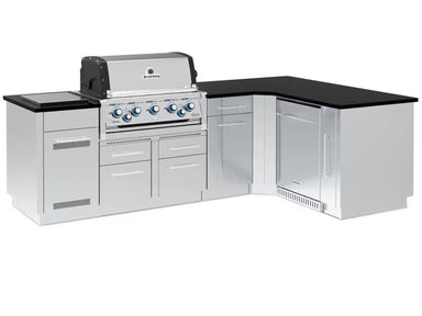 Full view of a Broil King Imperial S 590i outdoor kitchen island featuring a stainless steel built-in gas grill, black countertop, and integrated refrigerator.