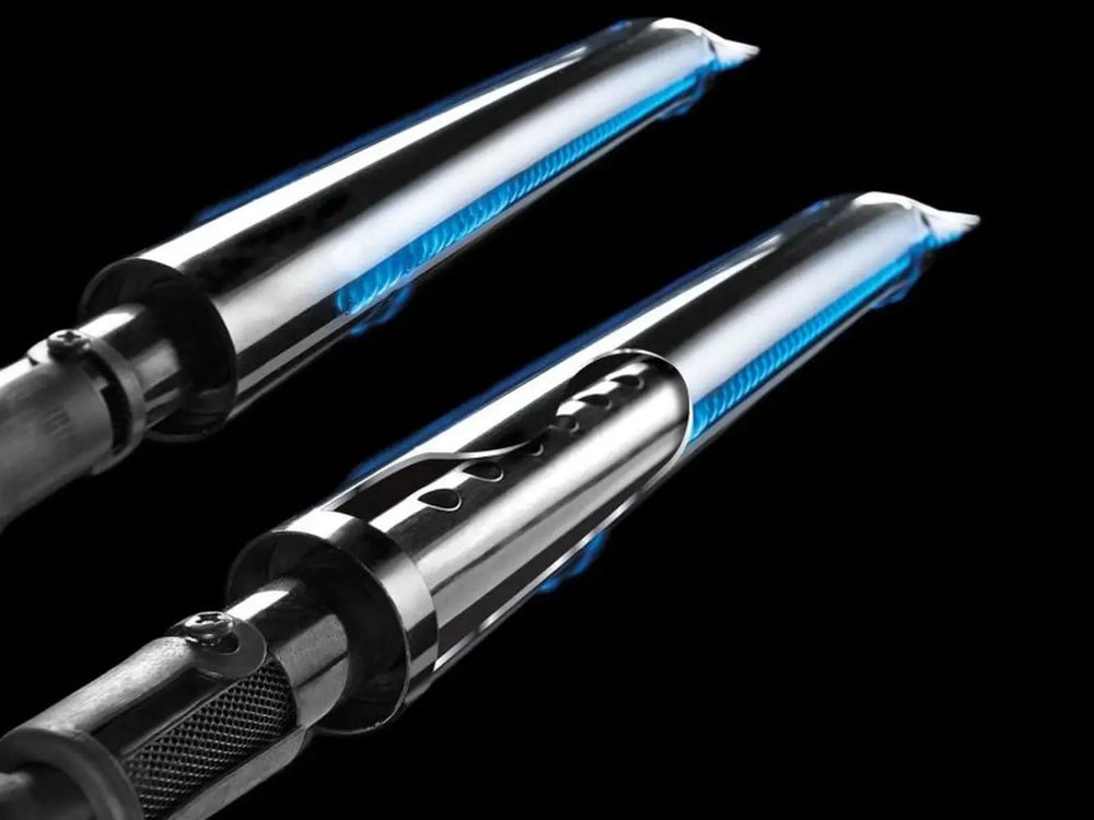 Detailed view of Broil King patented Dual-Tube stainless steel burners showing consistent blue flame for even heat distribution.