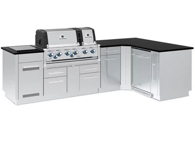 Fully assembled Broil King Imperial S 690iG L-shaped outdoor grill island with dual ovens, stainless steel cabinets, and black countertop.