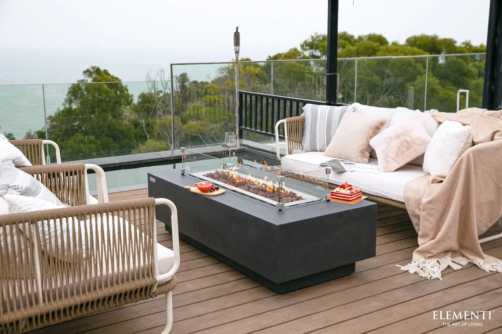 Protective glass shield accessory on the modern Elementi Granville OFG121DG Fire Table 60" Dark Gray.