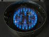 Close-up of a blue gas flame burning on one circular burner of the Broil King Porta-Chef Stove 200 portable propane stove.