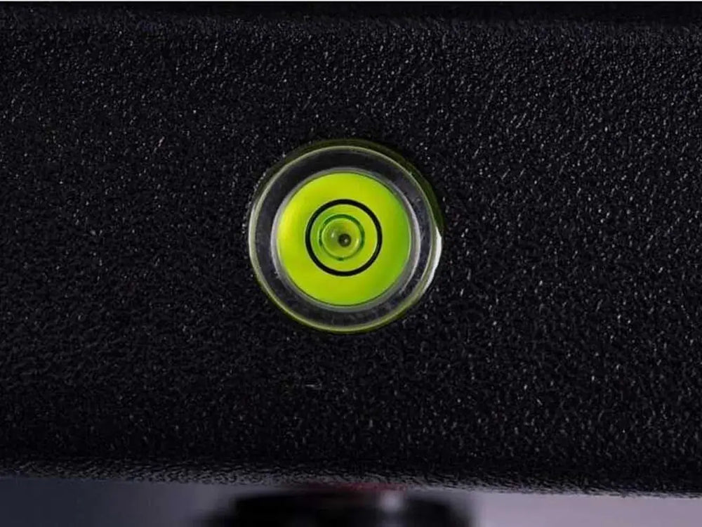 Close-up of a built-in green bubble level set into the black body of the Broil King Porta-Chef Stove 200 portable propane stove.