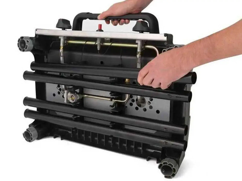 Underside view of the Broil King Porta-Chef Stove 200 with four black legs being attached for portable setup.