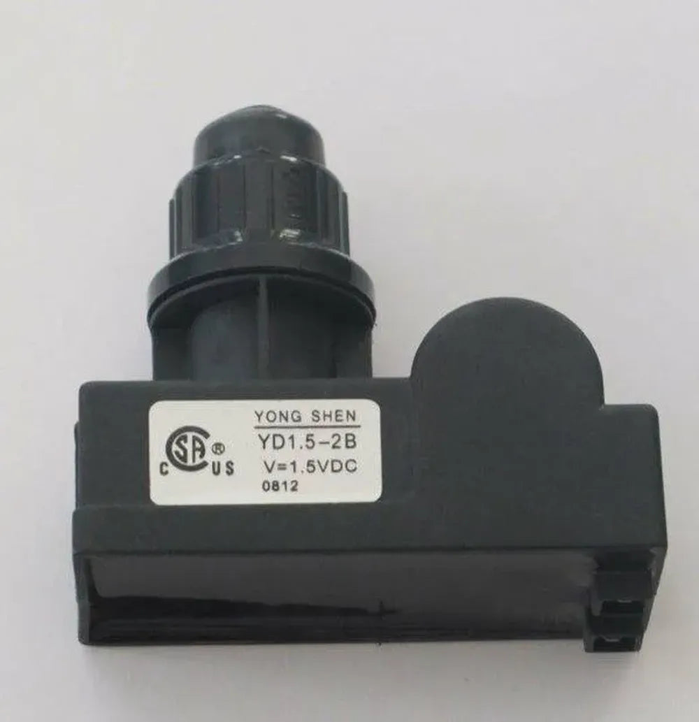 Close-up on Sunstone P-DBIgnitor double burner ignitor, AAA battery push-button spark igniter module for BBQ grills, black housing with knob.