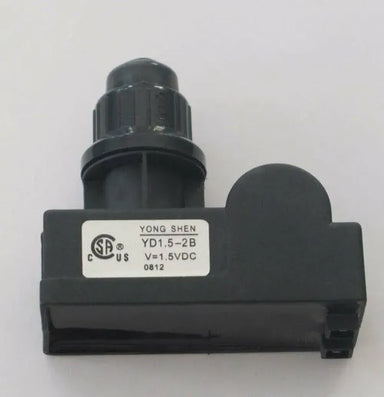 Close-up on Sunstone P-DBIgnitor double burner ignitor, AAA battery push-button spark igniter module for BBQ grills, black housing with knob.