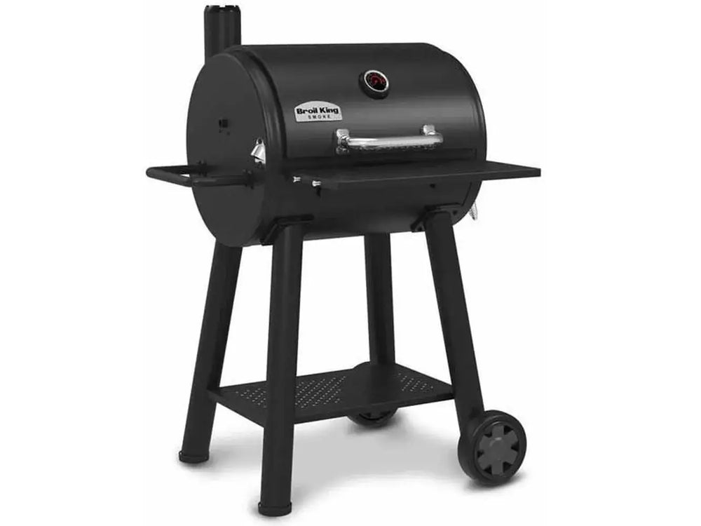 Angled product shot of the Broil King Regal Charcoal Grill 400 featuring a black steel body, side shelf, lower storage shelf, and two wheels.