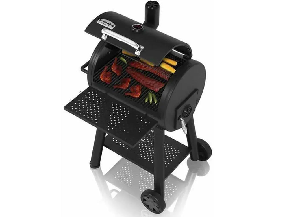 Broil King Regal Charcoal Grill 400 open with ribs, chicken, and vegetables cooking on cast iron grates.