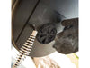 Close-up of the adjustable air vent and spring handle on the side firebox of the Broil King Regal Charcoal Offset 400 smoker grill.