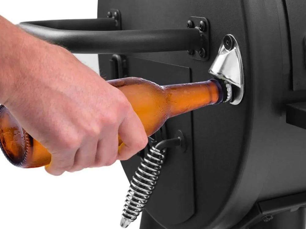 Built-in bottle opener mounted on the side of the Broil King Regal Charcoal Offset 500 smoker grill.