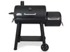 Broil King Regal Charcoal Offset 500 smoker grill with large main chamber, side firebox, front shelf, thermometer lid, and wheeled black steel cart on a light gray background.