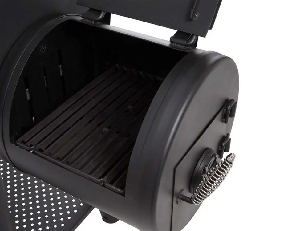 Open side firebox of the Broil King Regal Charcoal Offset 500 showing the charcoal chamber and spring-coil cool-touch handle.