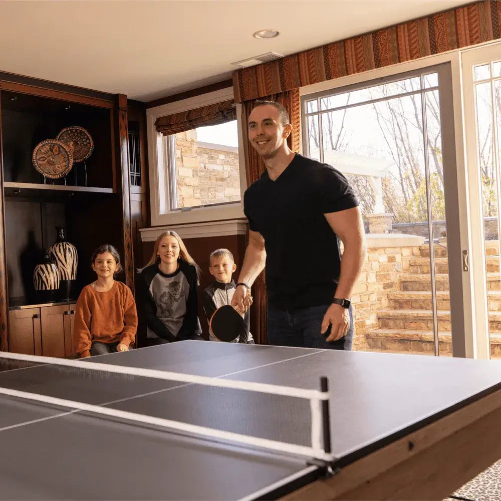 Family playing table tennis on Freetime Fun Rockford 7ft Multi-Game Table, great for basement or game room