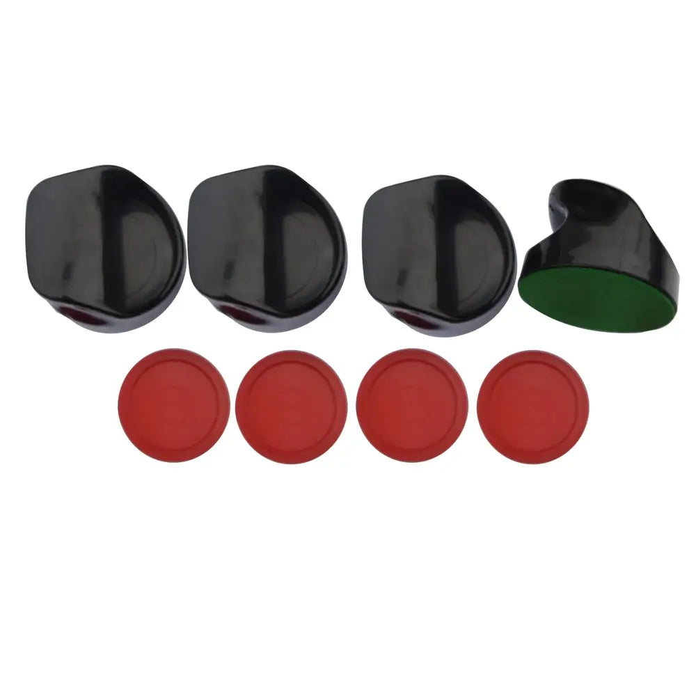 Air hockey accessories set including four black ergonomic strikers with green felt bottoms and four red plastic pucks.