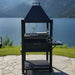 Tagwood BBQ BBQ12SI Gaucho charcoal grill with side shelf on lakeside stone patio