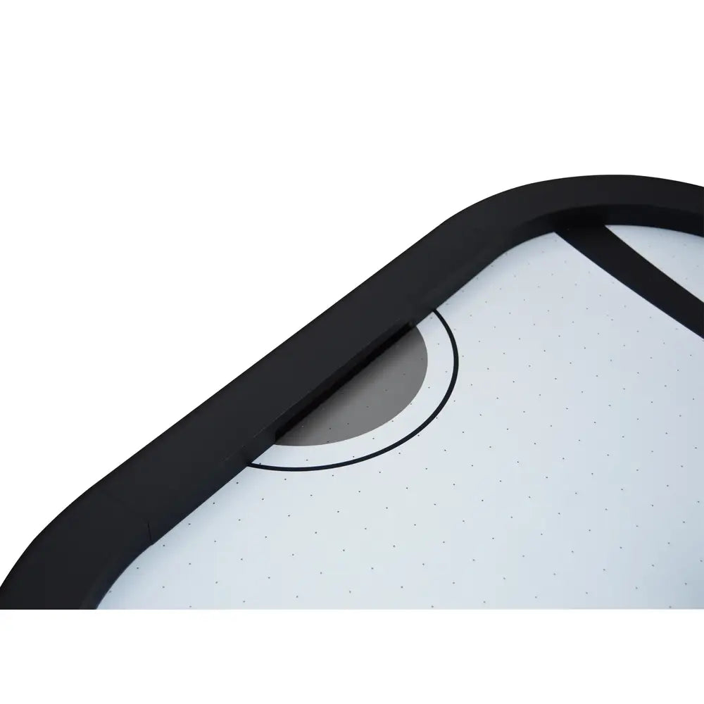 Close-up of air hockey table goal area with rounded black rail, smooth poly-sealed white playfield, and recessed puck return slot.