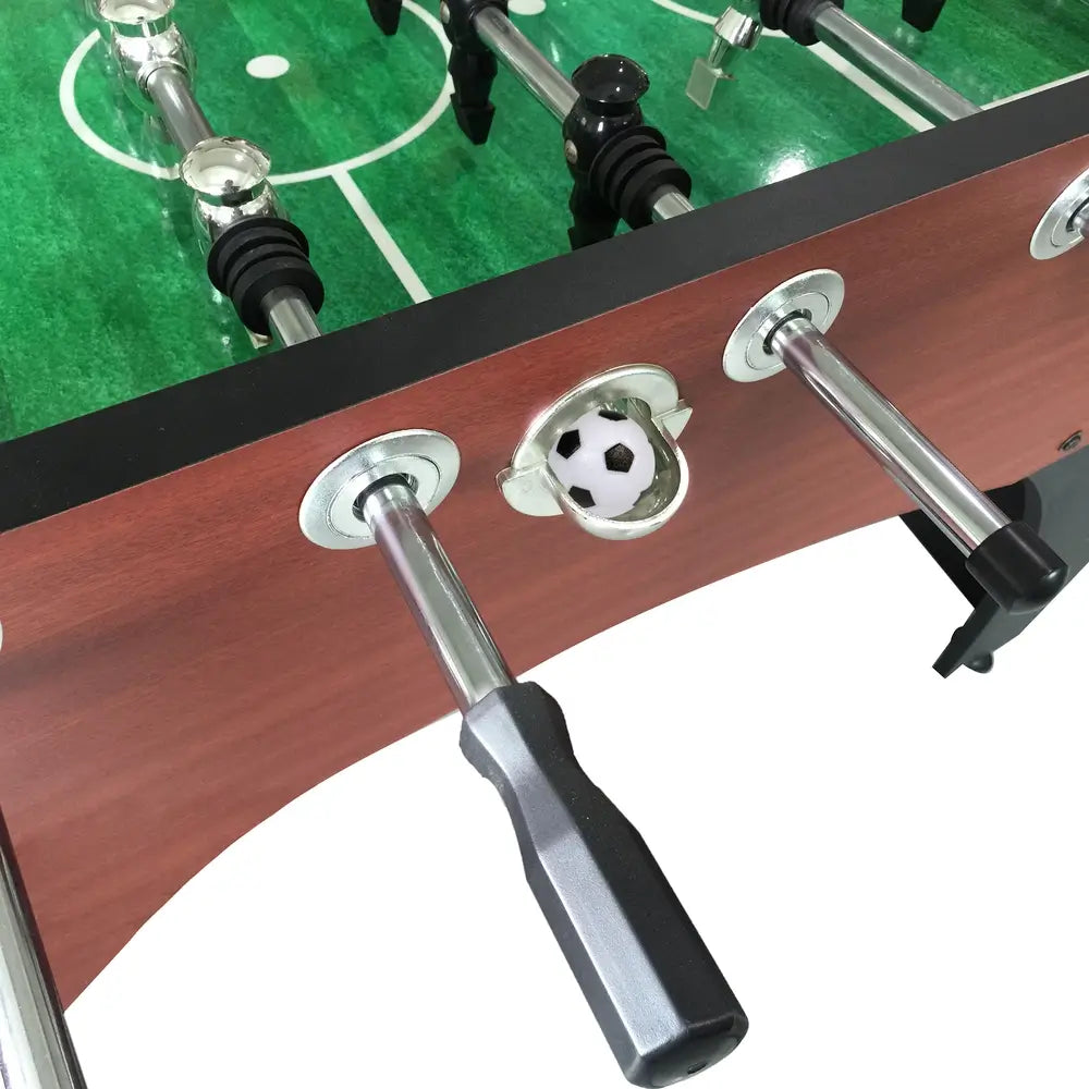 A close-up shot of the goal and ball-return area on the Hathaway Metropolitan 54-inch Foosball Table, showing a foosball resting in the return chute.