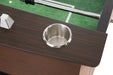Stainless steel recessed drink holder on a foosball table with a dark wood grain finish and green playing surface partially visible.