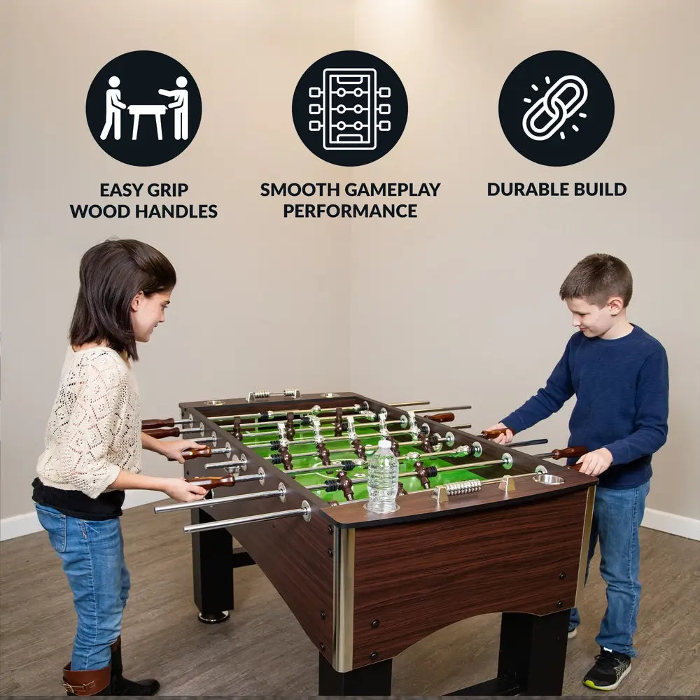 Two children playing on the Hathaway Primo foosball table, with labeled benefits: easy grip wood handles, smooth gameplay performance, and a durable build ideal for family fun.