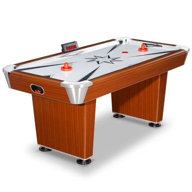 Angled view of the full Hathaway air hockey table showing two red pushers and a puck on the playfield. Design features include wood grain cabinet, chrome corners, electronic scoreboard, and central star graphic on the surface.