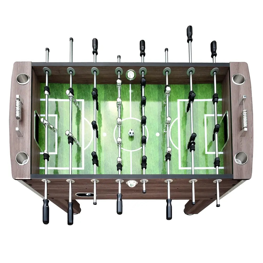 Top-down view of the foosball table’s full playfield with chrome and black player figures, green surface, and white field markings.