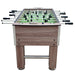 Front view of the full Hathaway Driftwood foosball table, showing rod arrangement, leg design, ball return slot, and game-ready layout.