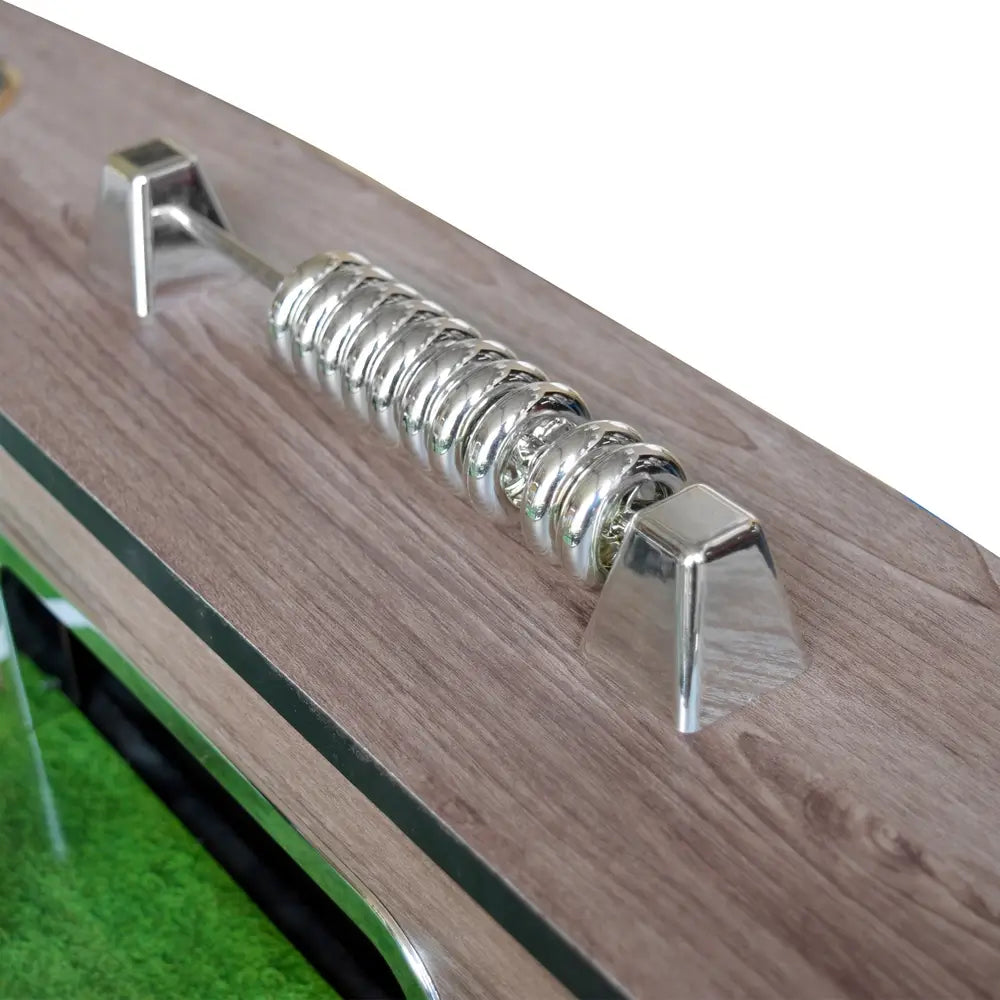 Detailed view of a chrome manual score keeper on the driftwood surface of the foosball table.