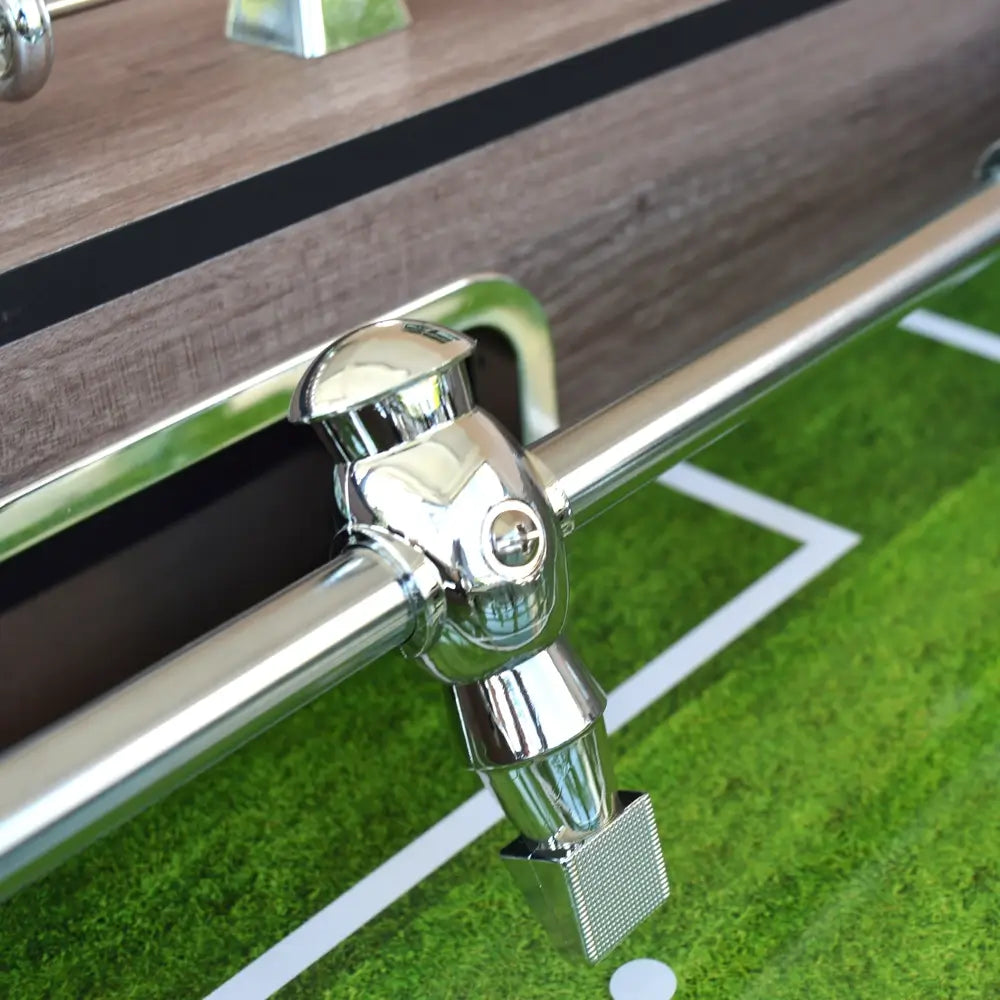 Zoomed-in view of a chrome ABS-molded foosball player on the Hathaway Driftwood table, emphasizing durable build and sleek design.