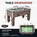 Dimensions of the Hathaway Driftwood foosball table: 54.75-in long, 29-in wide, 34-in high, with a 46.3-in by 26.5-in playfield; requires 9-ft by 9.5-ft of space.