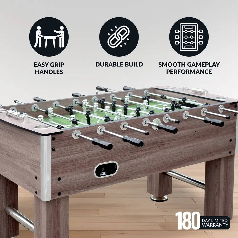 Hathaway Driftwood foosball table set up in a game room, highlighting smooth gameplay performance, easy grip handles, and durable construction with a 180-day limited warranty.
